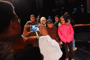 Detroit School of Arts students take a photo by smartphone with jazz legend Marcus Belgrave after a UMS school-day performance.