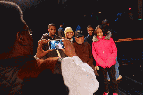 Detroit School of Arts students take a photo by smartphone with jazz legend Marcus Belgrave after a UMS school-day performance.